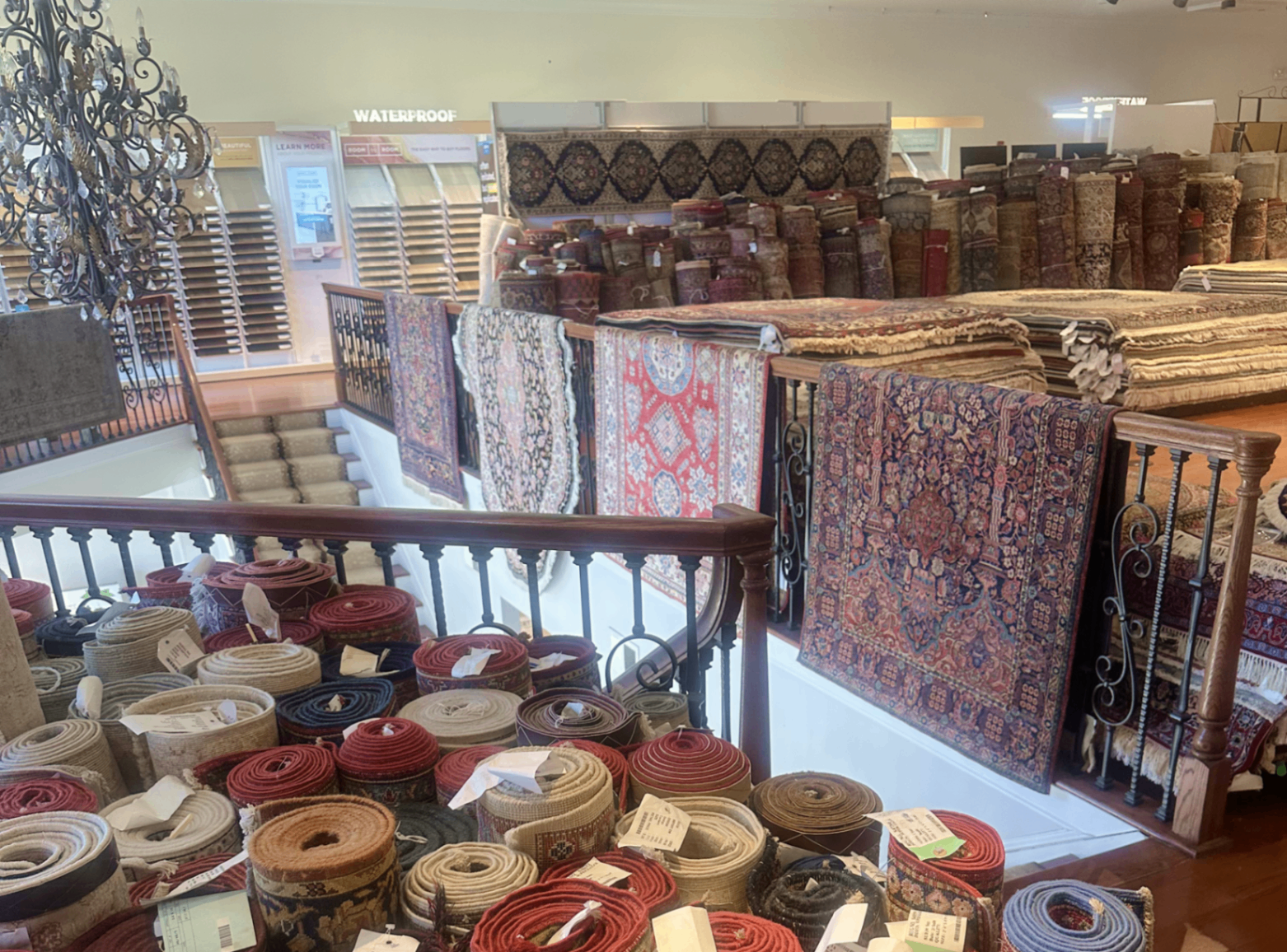 Curated rugs arranged across the gallery floor